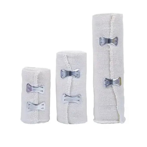 Three white bandages with silver clips 