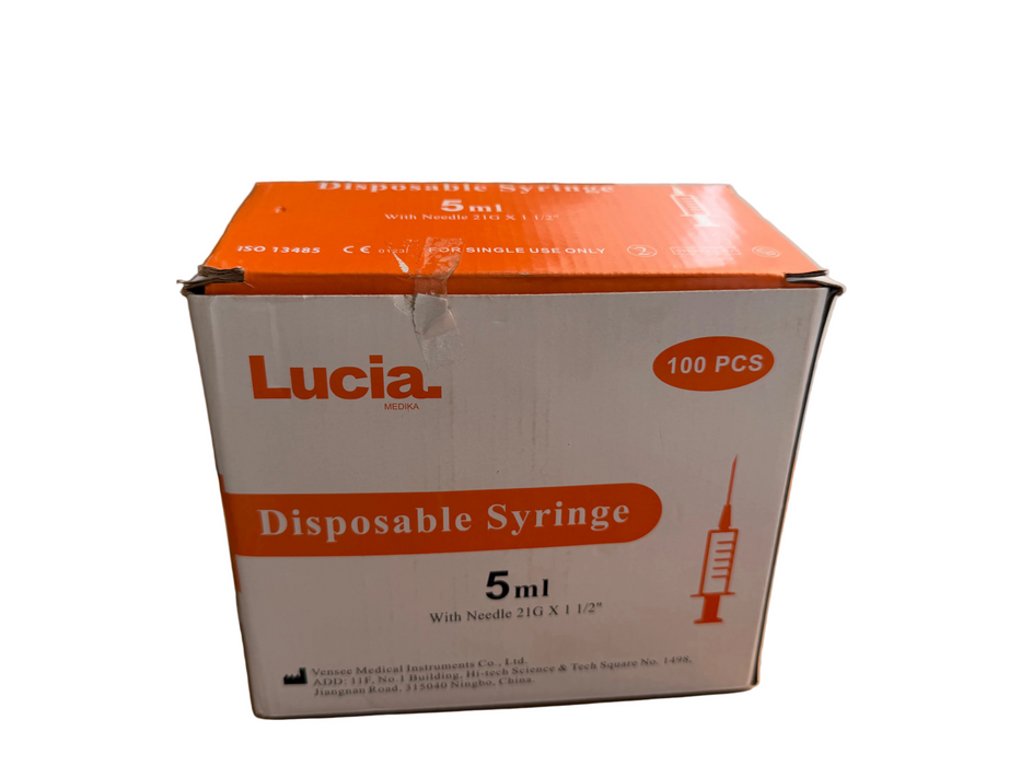 A box of 100 pieces of Lucia brand 5ml disposable syringes, featuring an orange and white design, placed on a wooden surface.