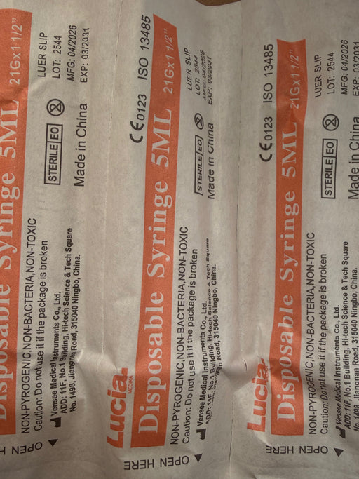 Three packages of Lucia Disposable Syringe 5ML sterile medical supplies on a white background.