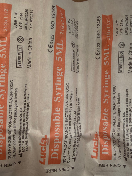 Three packages of Lucia Disposable Syringe 5ML sterile medical supplies on a white background.